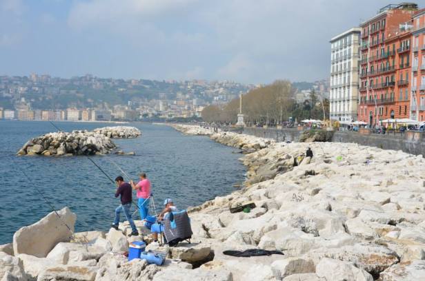 Some people fishing on the waterfront